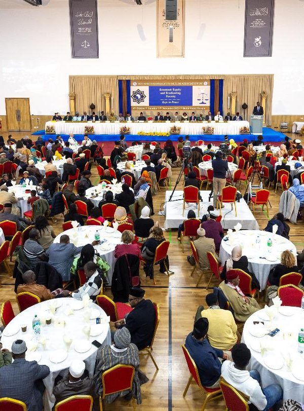 A group of people sitting at tables in a room Description automatically generated