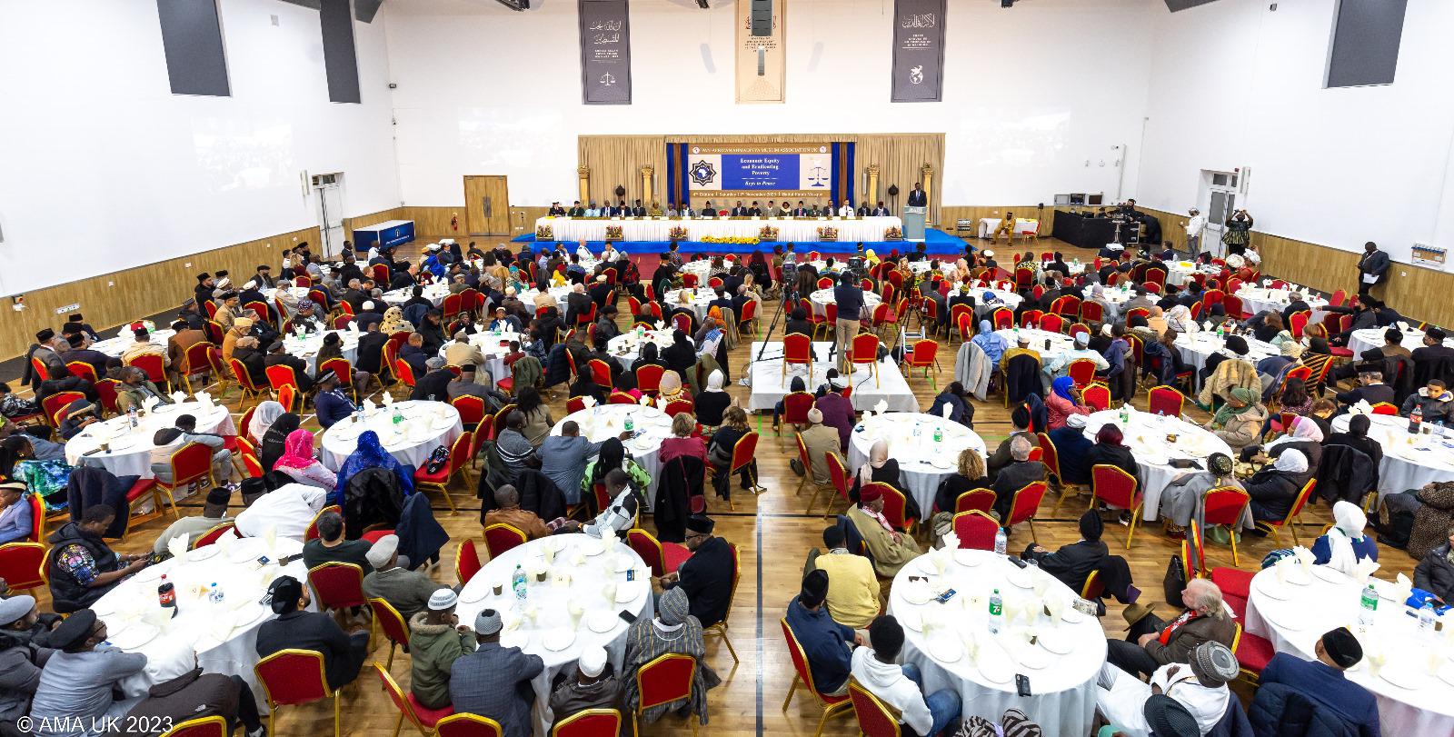 A group of people sitting at tables in a room Description automatically generated